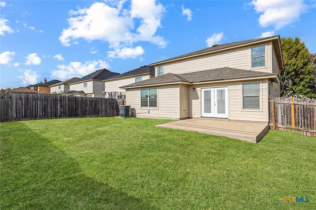 a backyard of a house with table and chairs