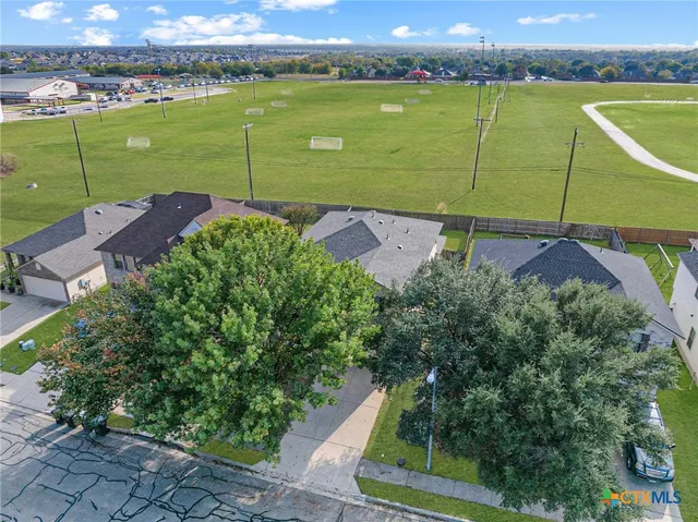 an aerial view of a golf course with a lake view