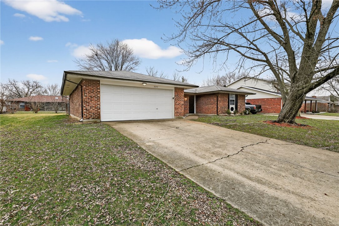 6070 Charlesgate Road Huber Heights, OH 45424 - Photo 3 of 29 This classic brick residence features a functional layout and an attached garage.