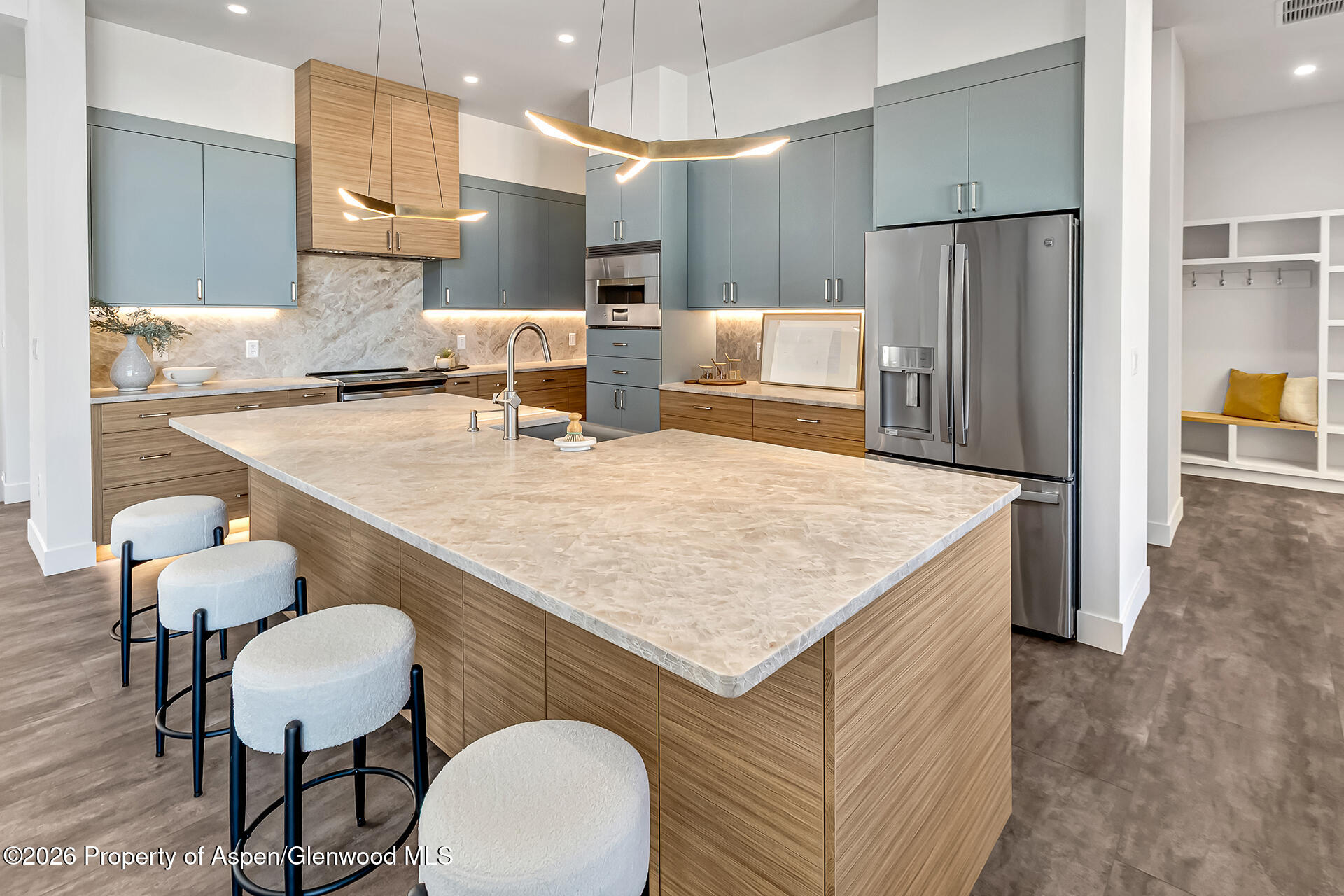 2216 Rimrock Road Grand Junction, CO 81507 - Photo 26 of 84 a kitchen with stainless steel appliances granite countertop a table chairs refrigerator and sink