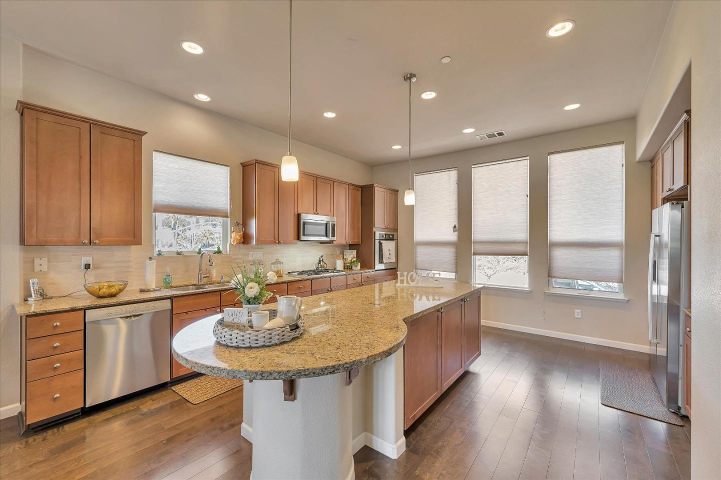3001 Ruby Avenue San Jose, CA 95135 - Photo 13 of 58 a large kitchen with kitchen island a sink stainless steel appliances and cabinets