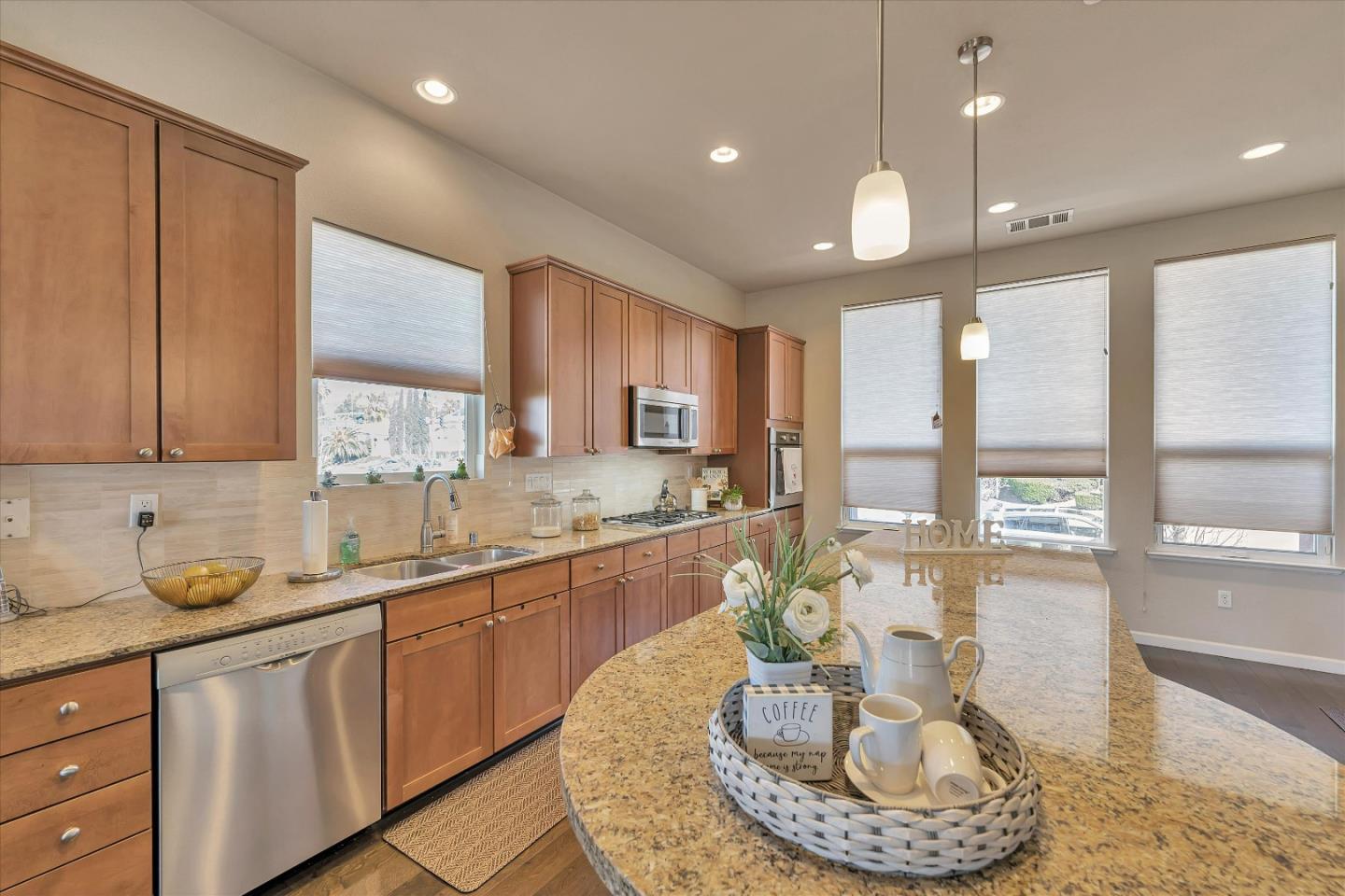 3001 Ruby Avenue San Jose, CA 95135 - Photo 14 of 58 a kitchen with sink refrigerator dining table and chairs