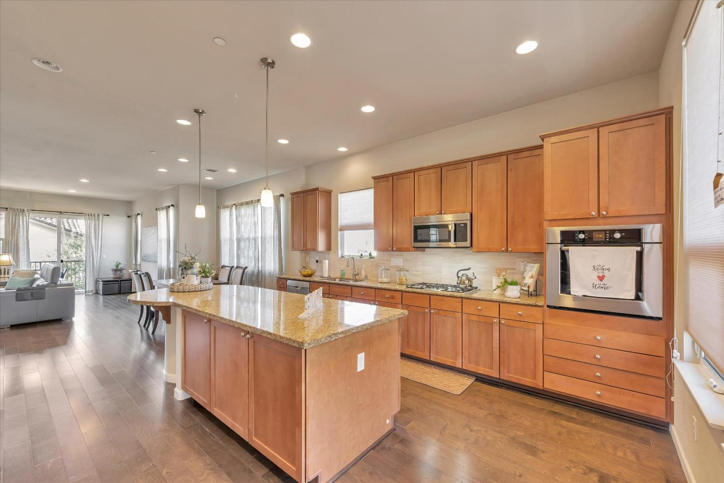 3001 Ruby Avenue San Jose, CA 95135 - Photo 15 of 58 a large kitchen with kitchen island lots of counter space a sink a window and chairs