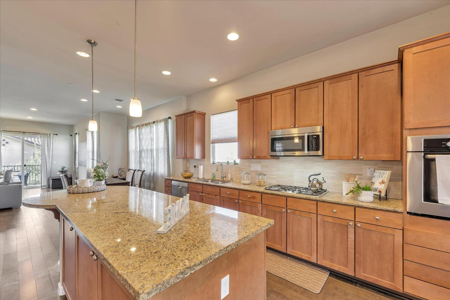 3001 Ruby Avenue San Jose, CA 95135 - Photo 16 of 58 a kitchen with stainless steel appliances granite countertop sink stove and cabinets