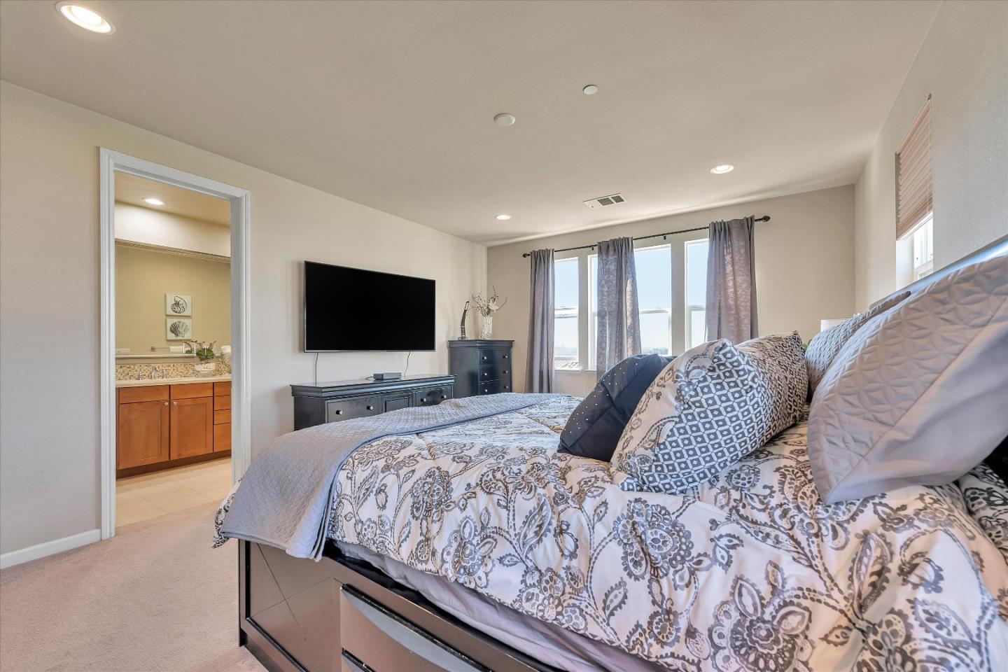 3001 Ruby Avenue San Jose, CA 95135 - Photo 33 of 58 a bedroom with a large bed and a flat screen tv