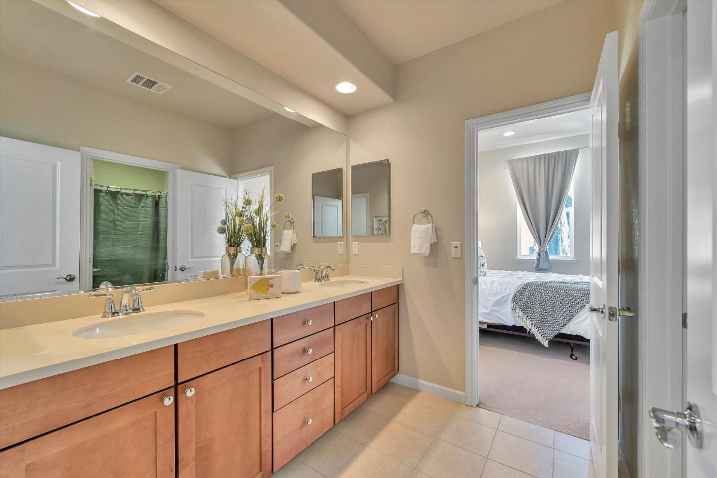 3001 Ruby Avenue San Jose, CA 95135 - Photo 38 of 58 a en suite bathroom with a double vanity sink and a mirror