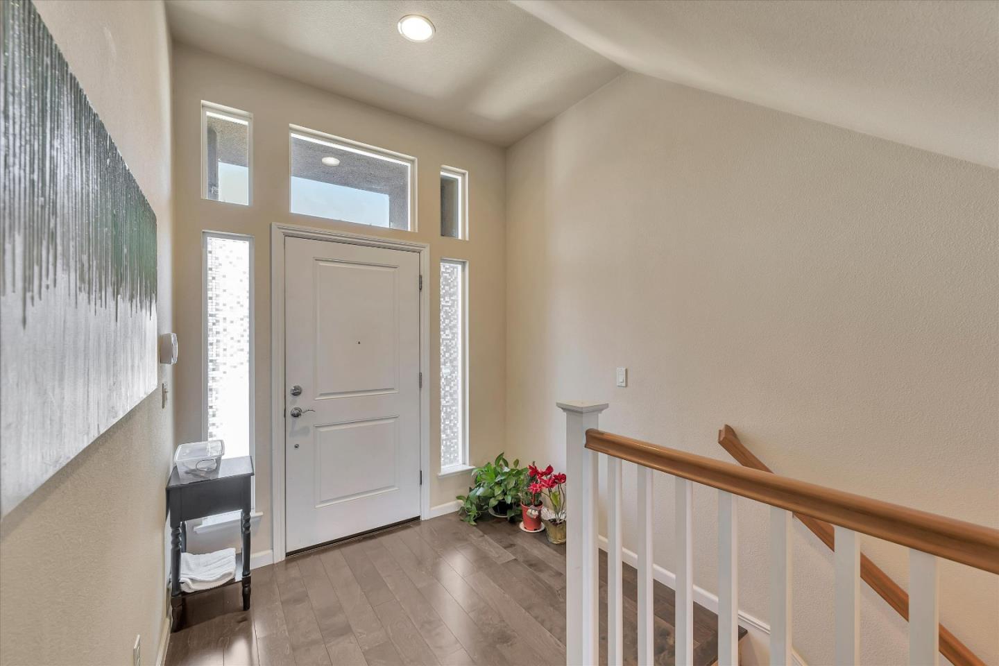 3001 Ruby Avenue San Jose, CA 95135 - Photo 5 of 58 a view of a hallway and an entryway with wooden floor