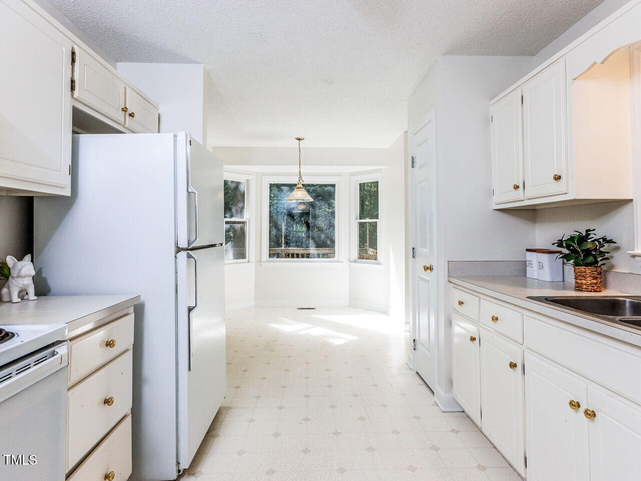 216 Deep Pool Court Benson, NC 27504 - Photo 12 of 37 a kitchen with white cabinets and window
