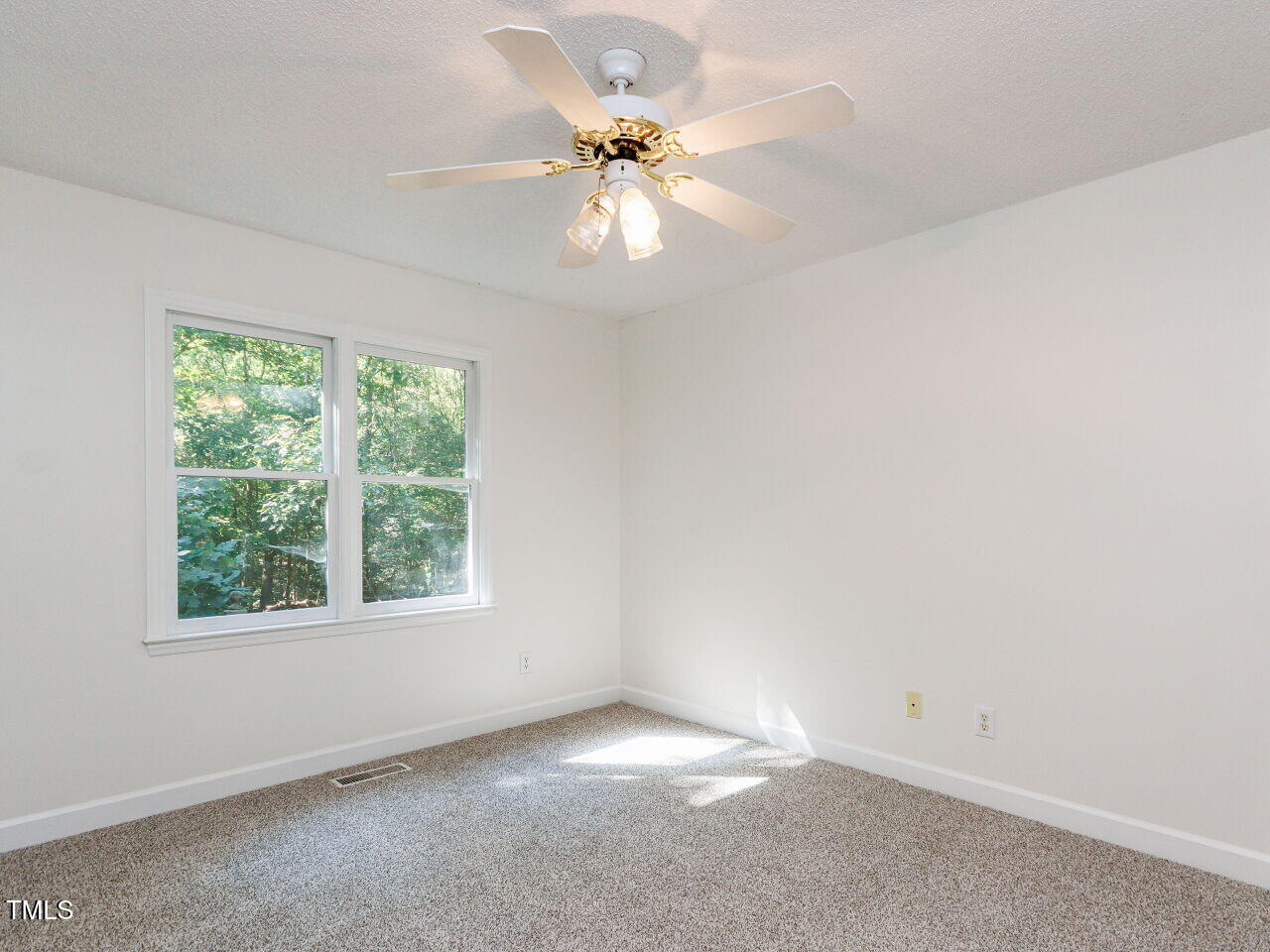 216 Deep Pool Court Benson, NC 27504 - Photo 16 of 37 an empty room with a window and a fan