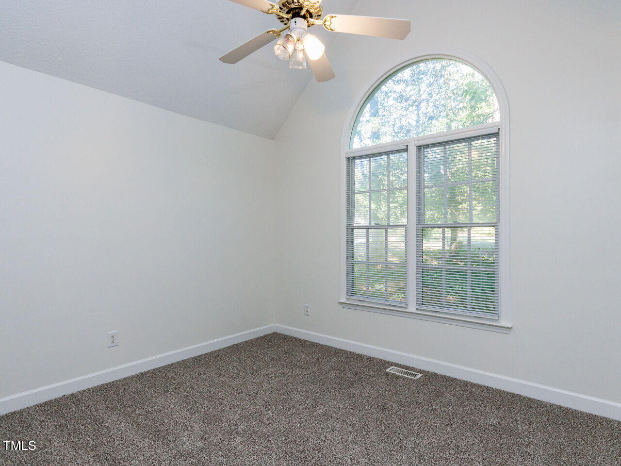 216 Deep Pool Court Benson, NC 27504 - Photo 21 of 37 an empty room with a chandelier fan and windows