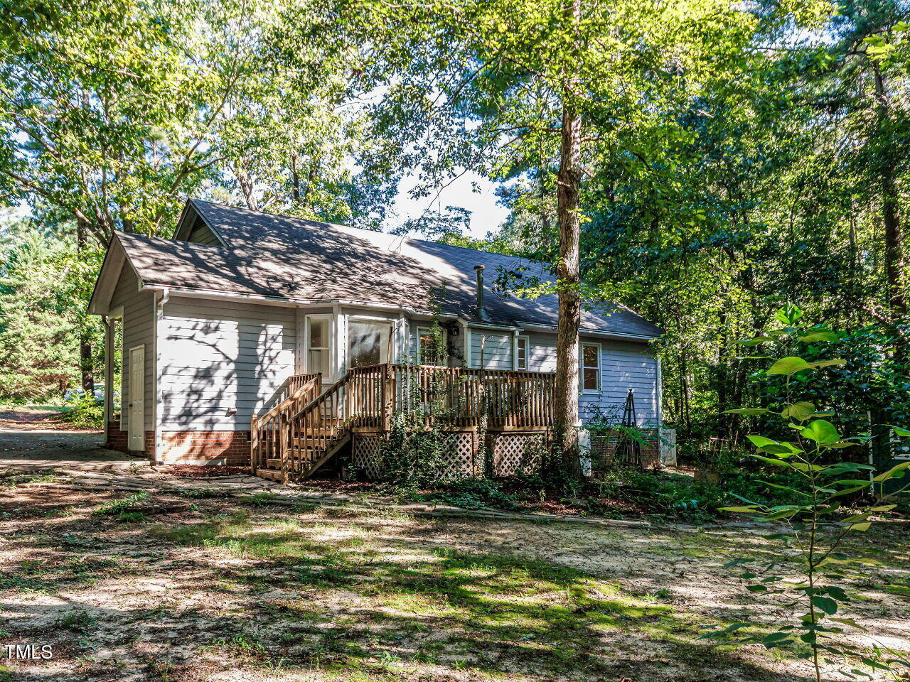 216 Deep Pool Court Benson, NC 27504 - Photo 31 of 37 a view of a house with large tree and wooden fence
