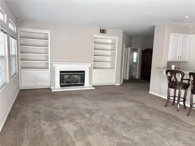 a view of a livingroom with furniture and a fireplace