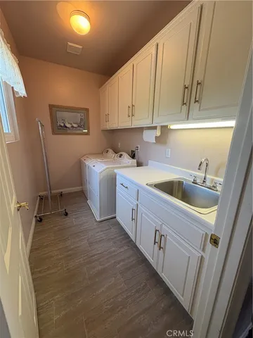 a kitchen with a sink a refrigerator and cabinets