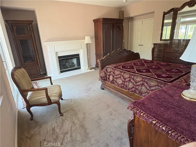 a bedroom with a bed and a fireplace