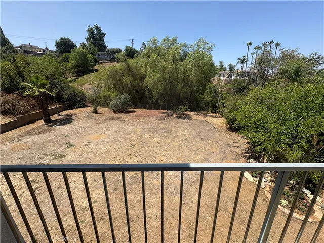 a view of a balcony with wooden fence