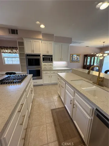 a kitchen with a sink stove and cabinets