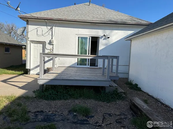 a view of a house with a wooden deck