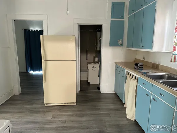 a kitchen with a refrigerator sink and cabinets