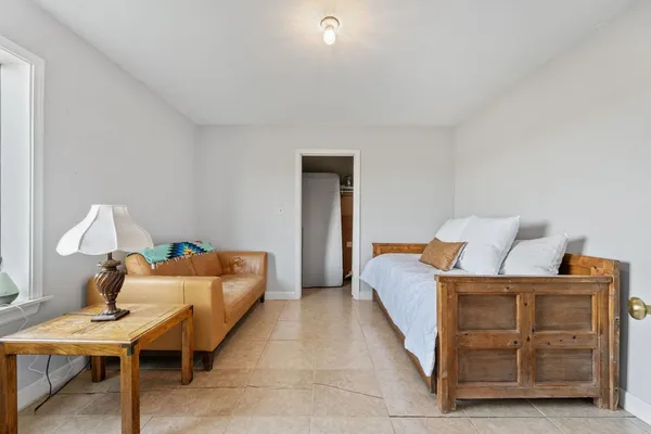 a view of a room with wooden chairs