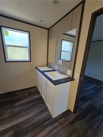 a kitchen with sink cabinets and wooden floor