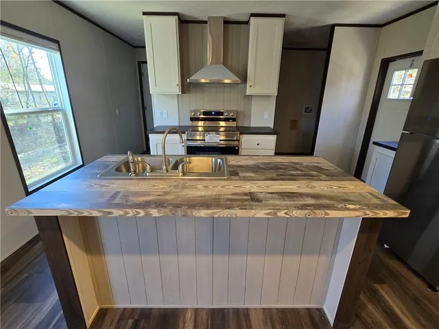 a kitchen with kitchen island granite countertop stove top oven and sink