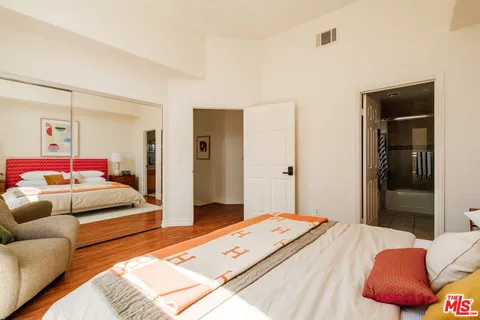 a bedroom with a bed and a couch