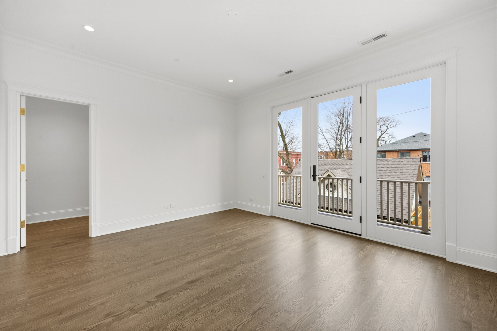 3902 North Hamilton Avenue Chicago, IL 60618 - Photo 43 of 67 an empty room with wooden floor and windows