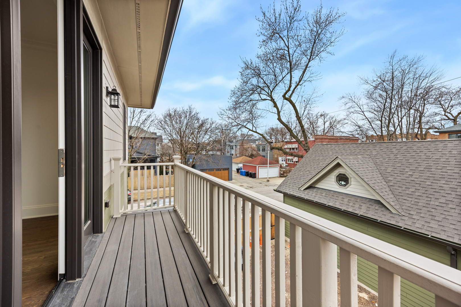 3902 North Hamilton Avenue Chicago, IL 60618 - Photo 44 of 67 a view of a balcony with wooden floor and fence