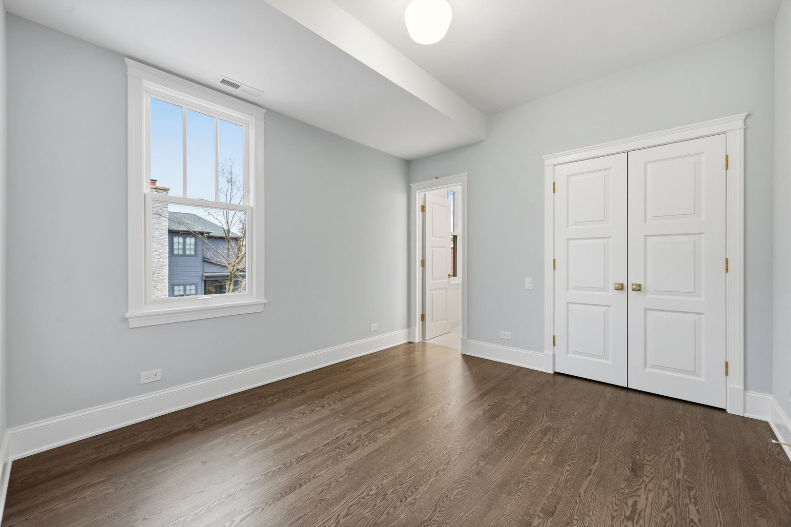 3902 North Hamilton Avenue Chicago, IL 60618 - Photo 49 of 67 a view of an empty room with wooden floor and a window