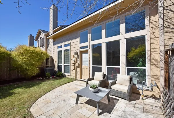 a balcony with furniture and garden view