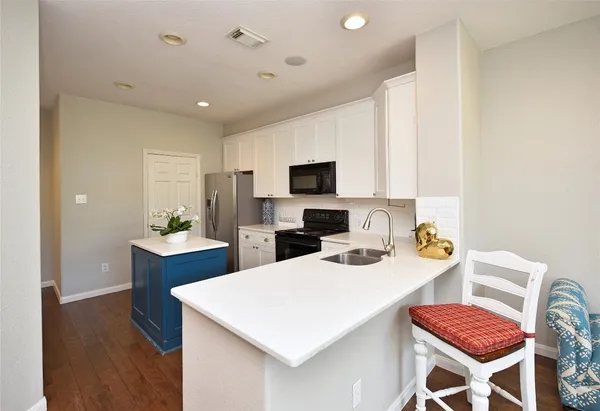 a kitchen that has a table and chairs in it