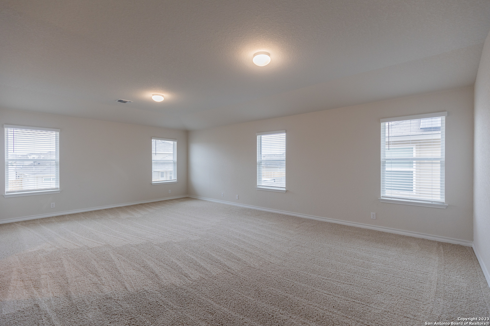 9819 Bratten Rise San Antonio, TX 78254 - Photo 19 of 37 an empty room with windows