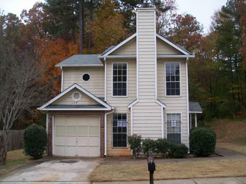 1985 Glenwood Downs Drive Decatur, GA 30035 - Photo 1 of 1 a front view of a house with a yard and garage