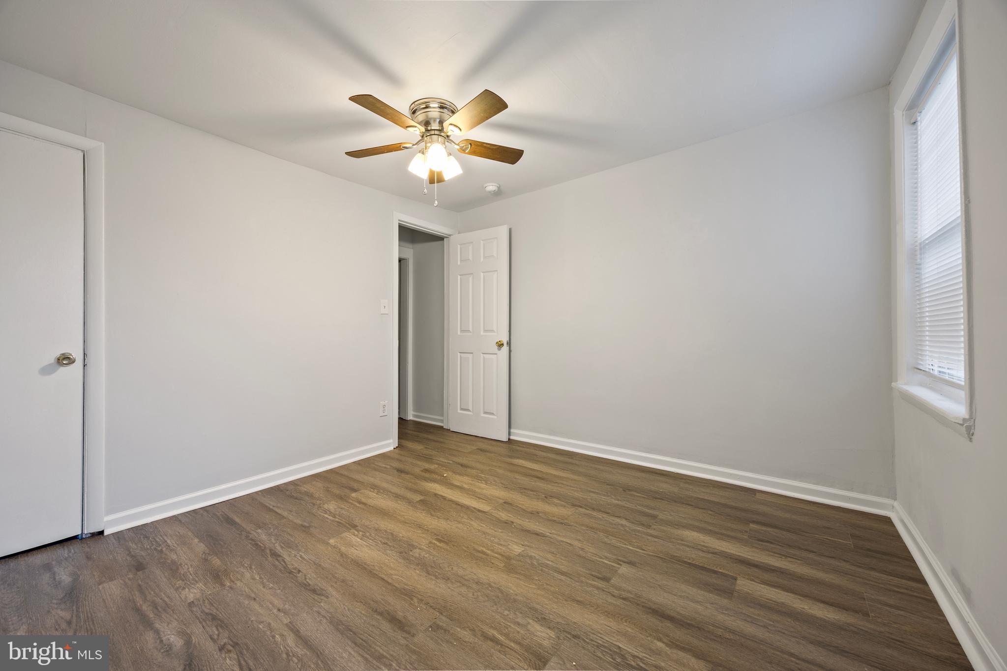 2012 Etting Street Baltimore, MD 21217 - Photo 11 of 23 a view of an empty room with wooden floor and window
