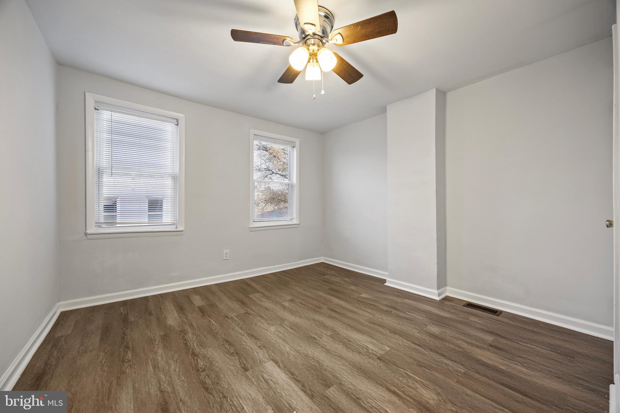 2012 Etting Street Baltimore, MD 21217 - Photo 9 of 23 a view of an empty room with window and wooden floor