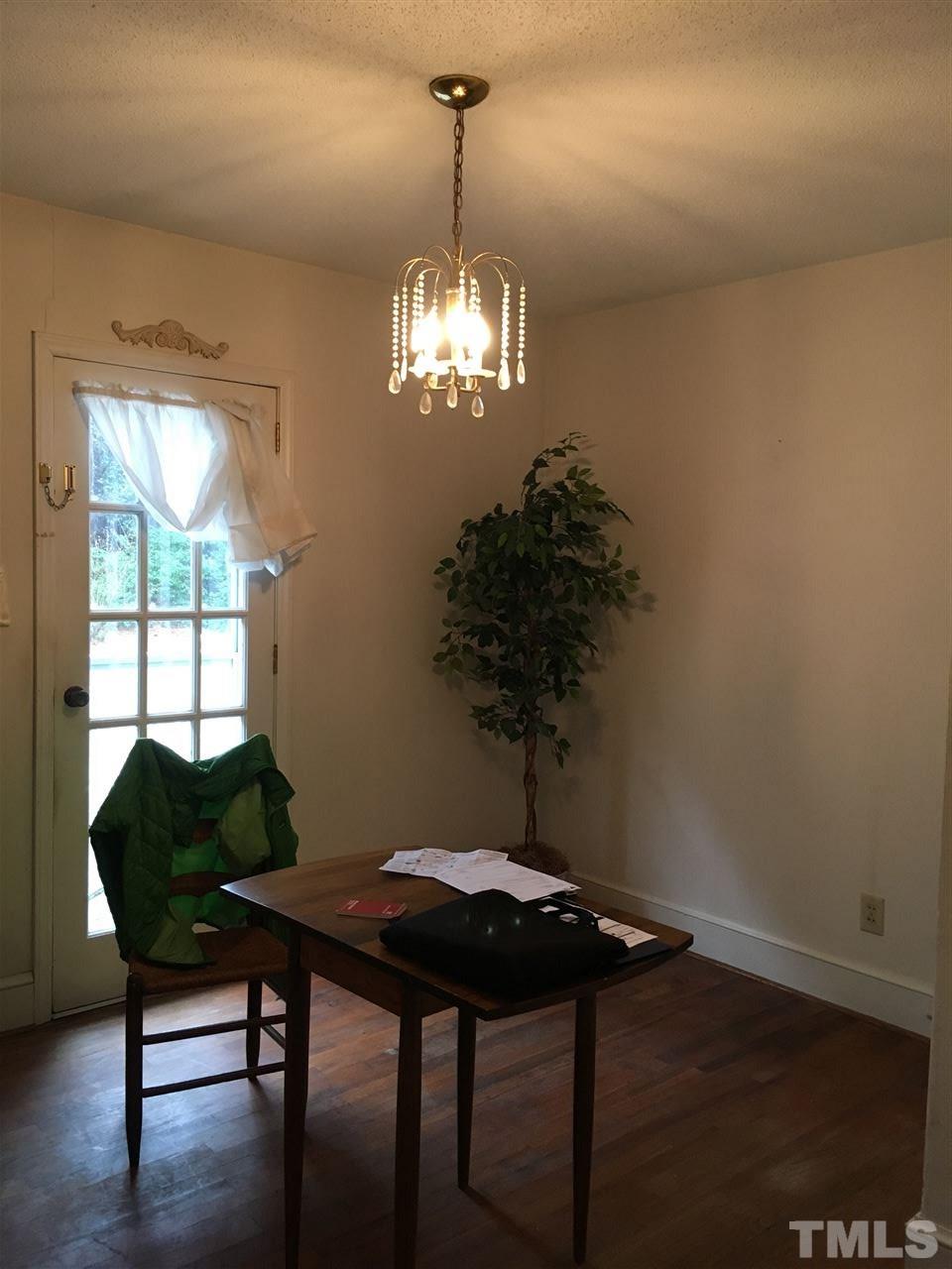 432 Raleigh View Road Raleigh, NC 27610 - Photo 2 of 3 a view of a dining room with furniture a chandelier and wooden floor