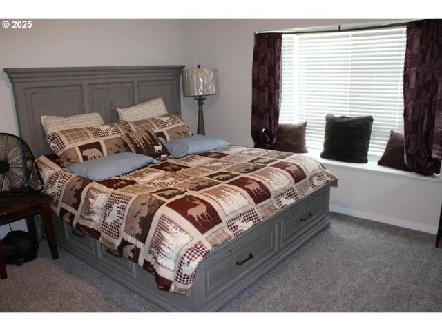 a bedroom with a bed with wooden floor