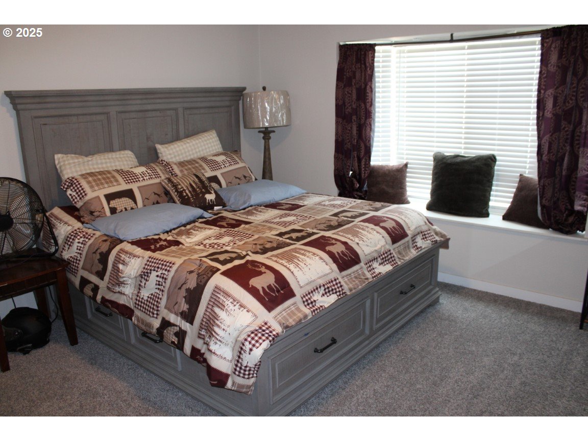 526 Southeast 15th Street Pendleton, OR 97801 - Photo 24 of 31 a bedroom with a bed and wooden floor