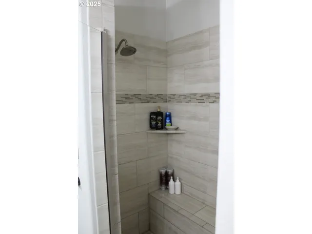 a view of walk in closet with clothes