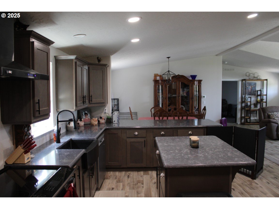 526 Southeast 15th Street Pendleton, OR 97801 - Photo 7 of 31 a kitchen with a kitchen island sink stove and microwave