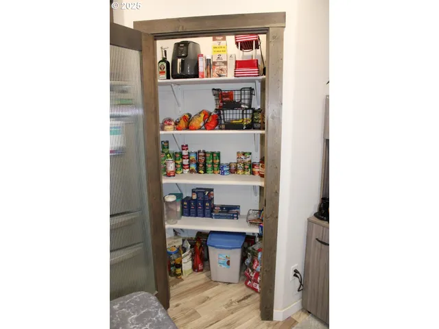 a kitchen with a refrigerator and a stove