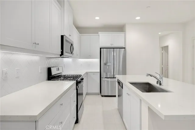a kitchen with a sink a stove and refrigerator