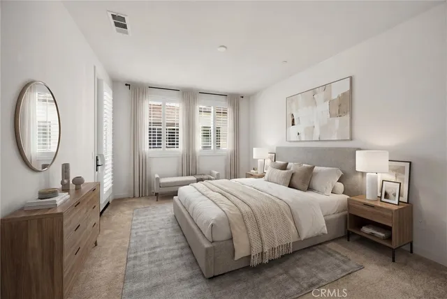 a bedroom with a bed a mirror and a large window