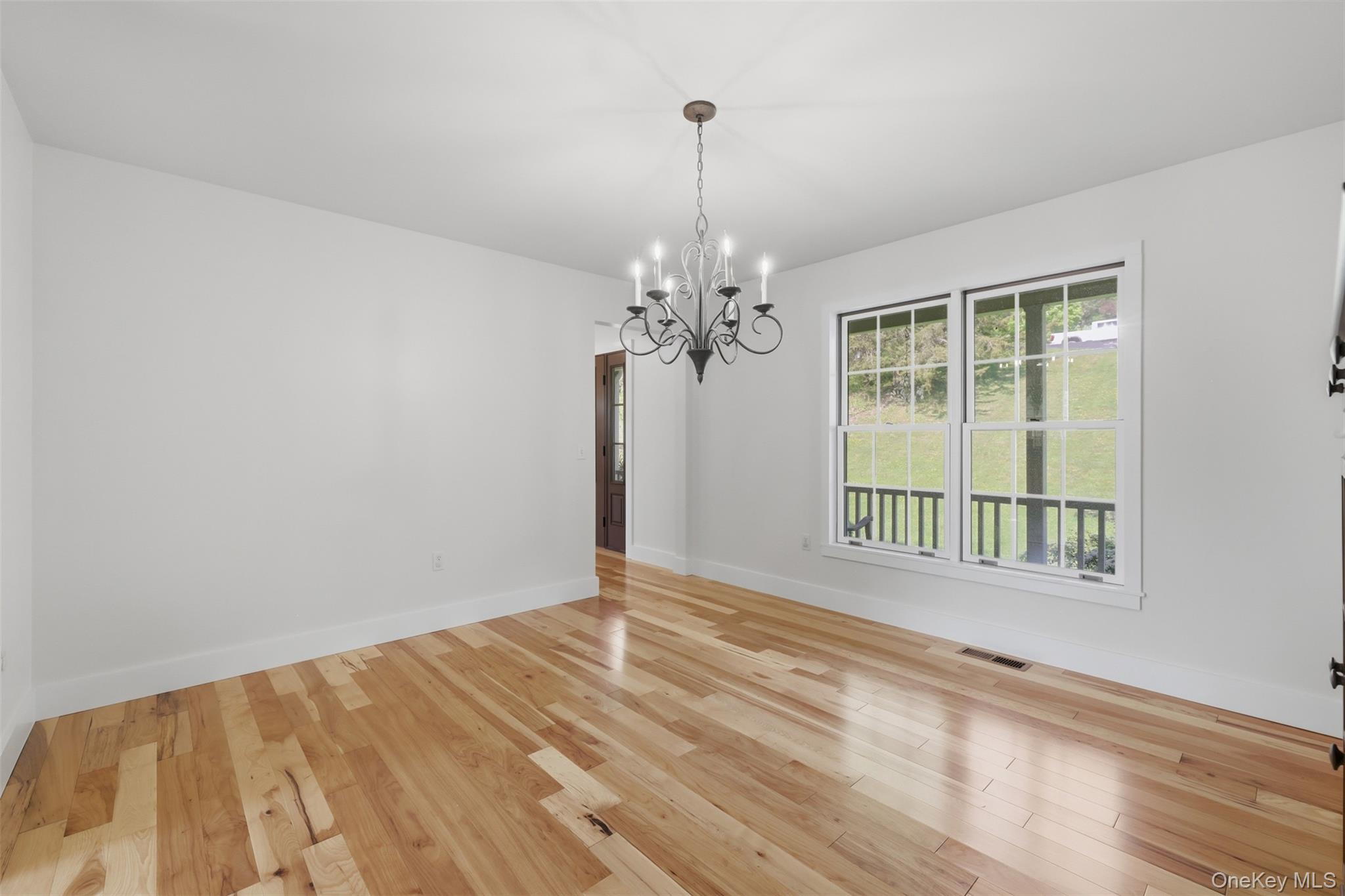 233 Devon Farms Road Stormville, NY 12582 - Photo 20 of 48 a view of a livingroom with wooden floor and a chandelier