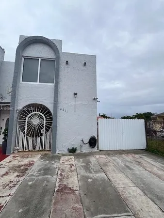 a view of a house with backyard and barbeque area