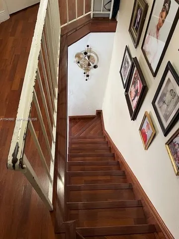 a bedroom with a bed and a mirror on dresser