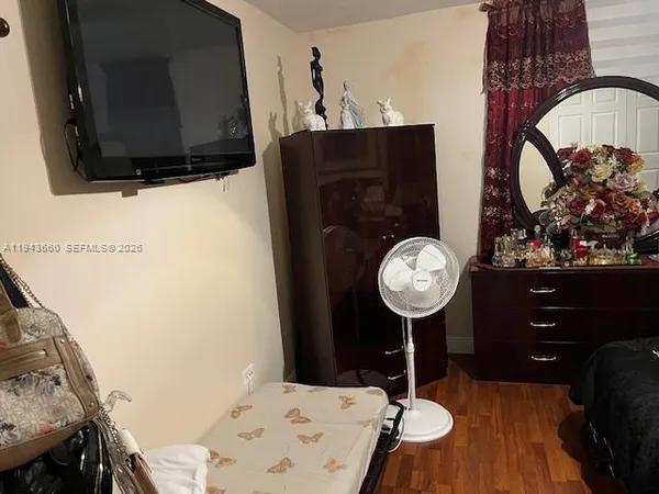 a bedroom with a bed and a dresser