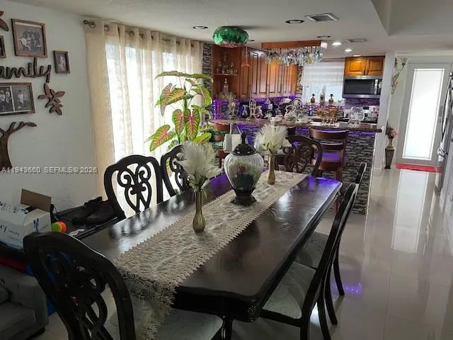 a kitchen with a stove a refrigerator and a dining table