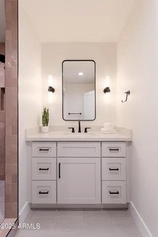 a bathroom with a sink vanity and mirror