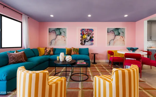 a living room with furniture and painting on the wall